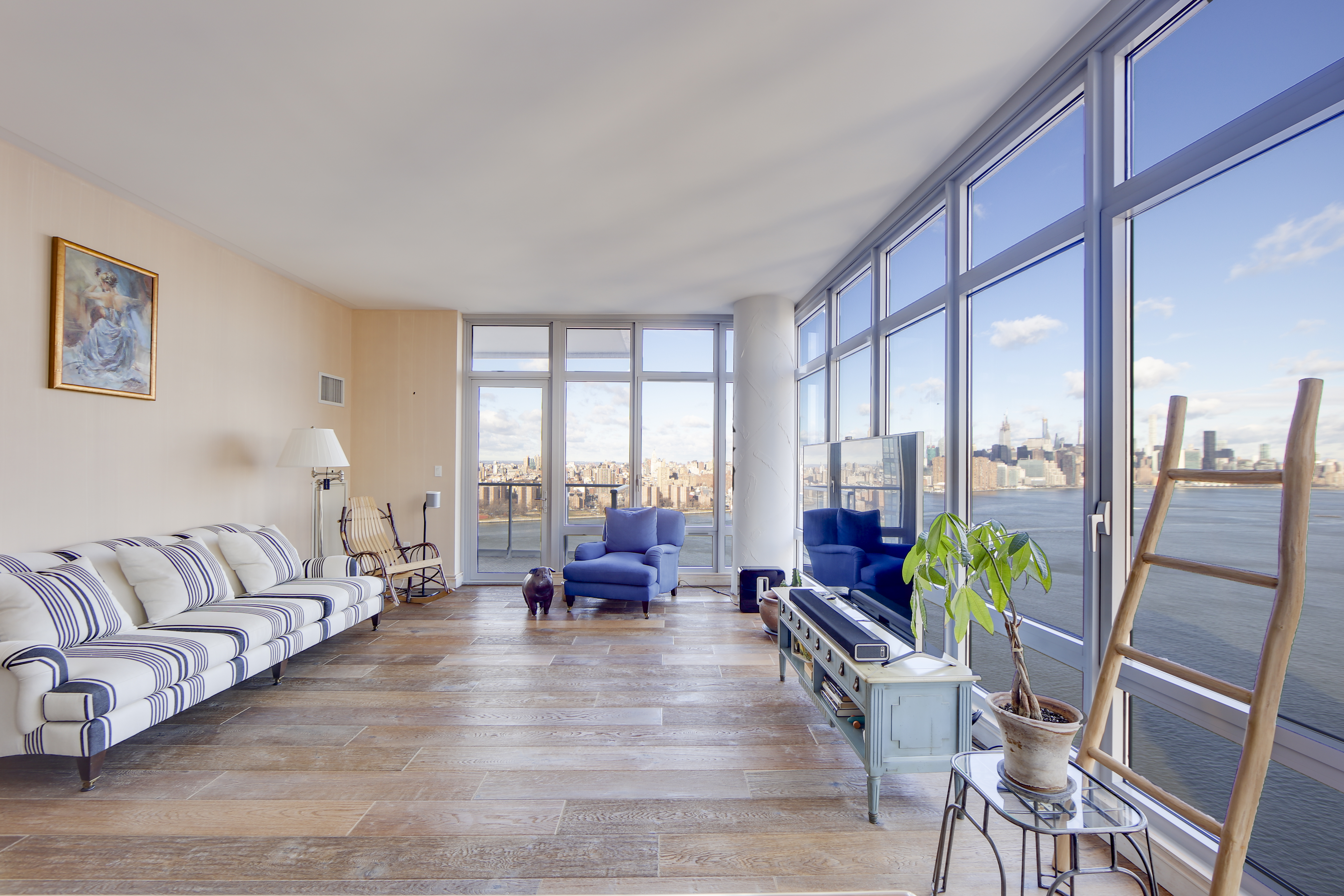 2 Northside Piers, Unit 27P Brooklyn, NY 11249 - Photo 2 of 19 a living room with furniture and a large window