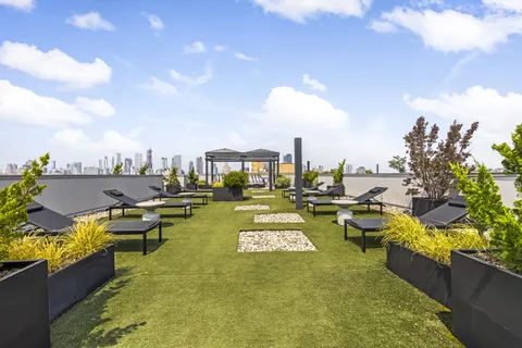 a view of a swimming pool with outdoor seating