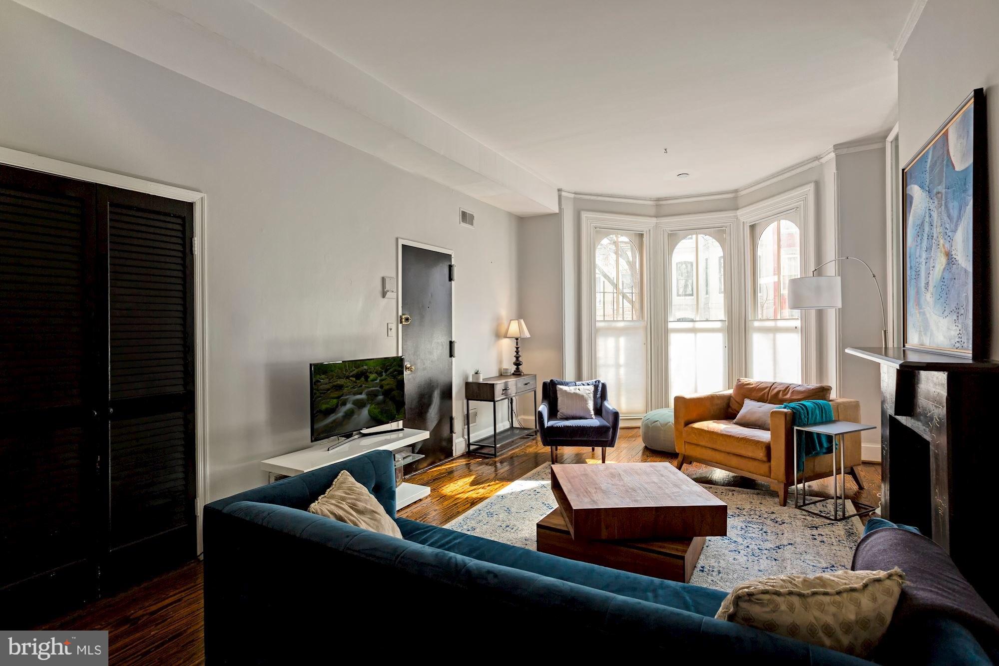 1317 Corcoran Street Northwest Washington, DC 20009 - Photo 40 of 47 a living room with furniture and a flat screen tv