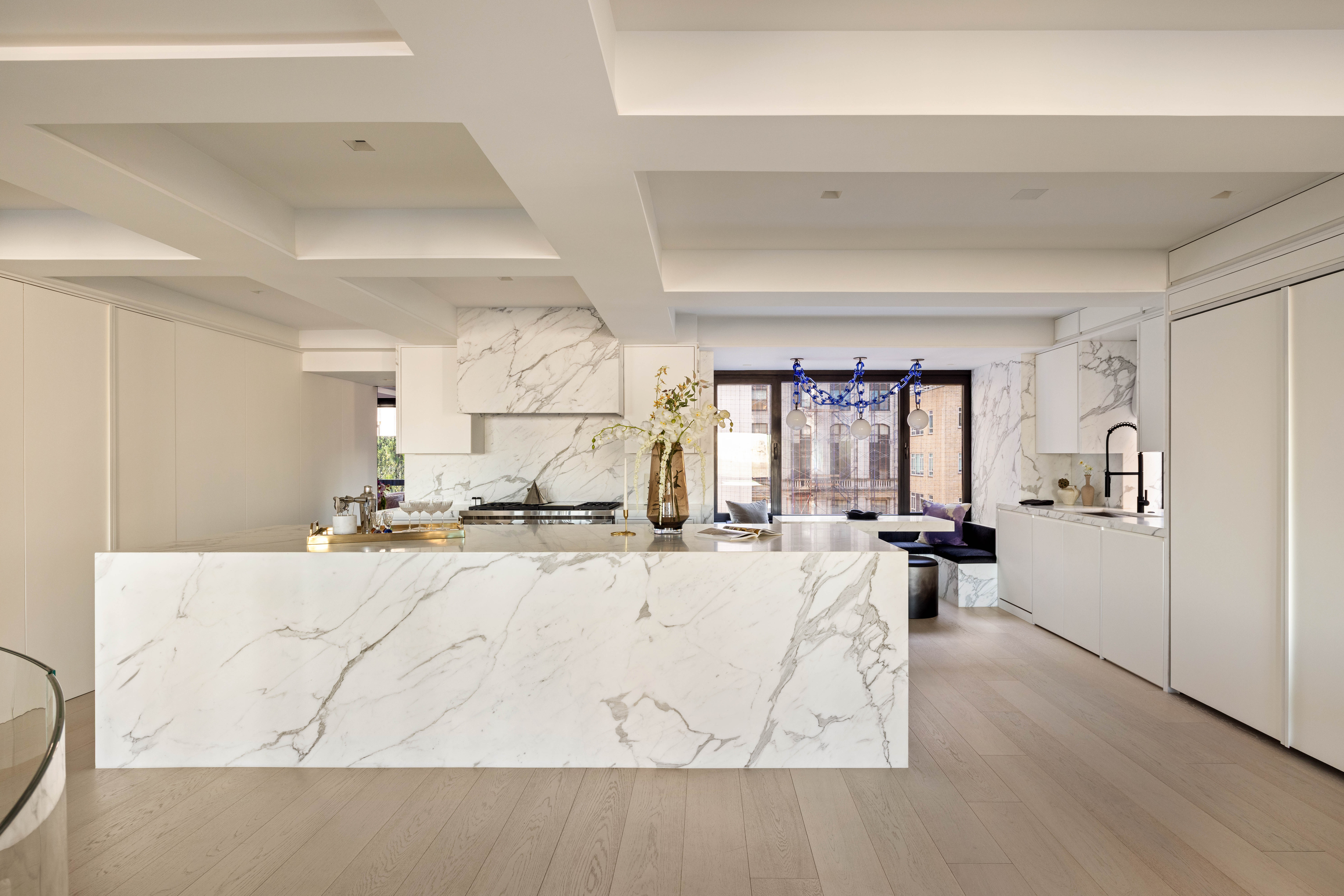 230 Central Park South Manhattan, NY 10019 - Photo 6 of 23 a large white kitchen with wooden floor