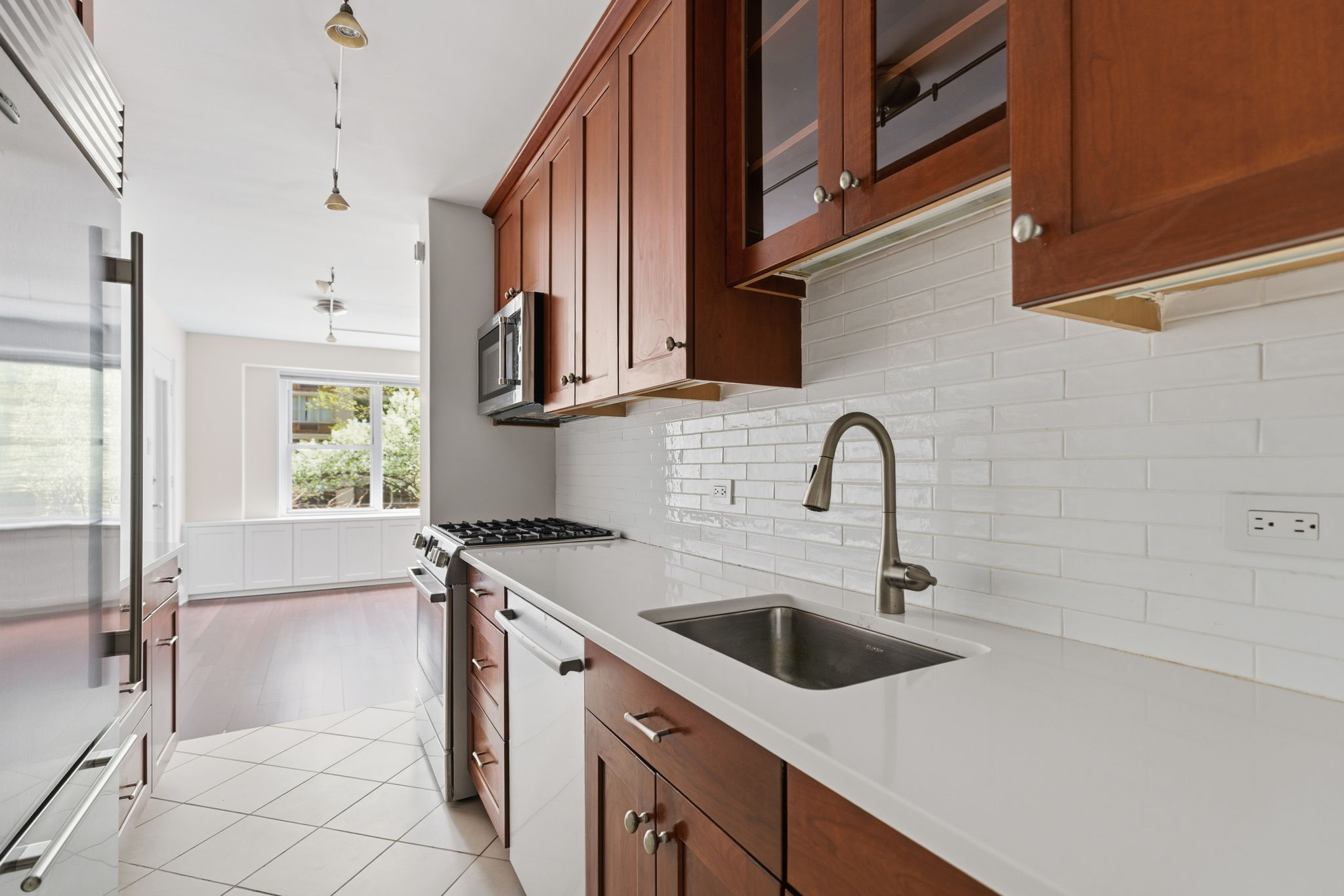 360 East 72nd Street, Unit A306 Manhattan, NY 10021 - Photo 4 of 17 a view of a kitchen with a sink and cabinets