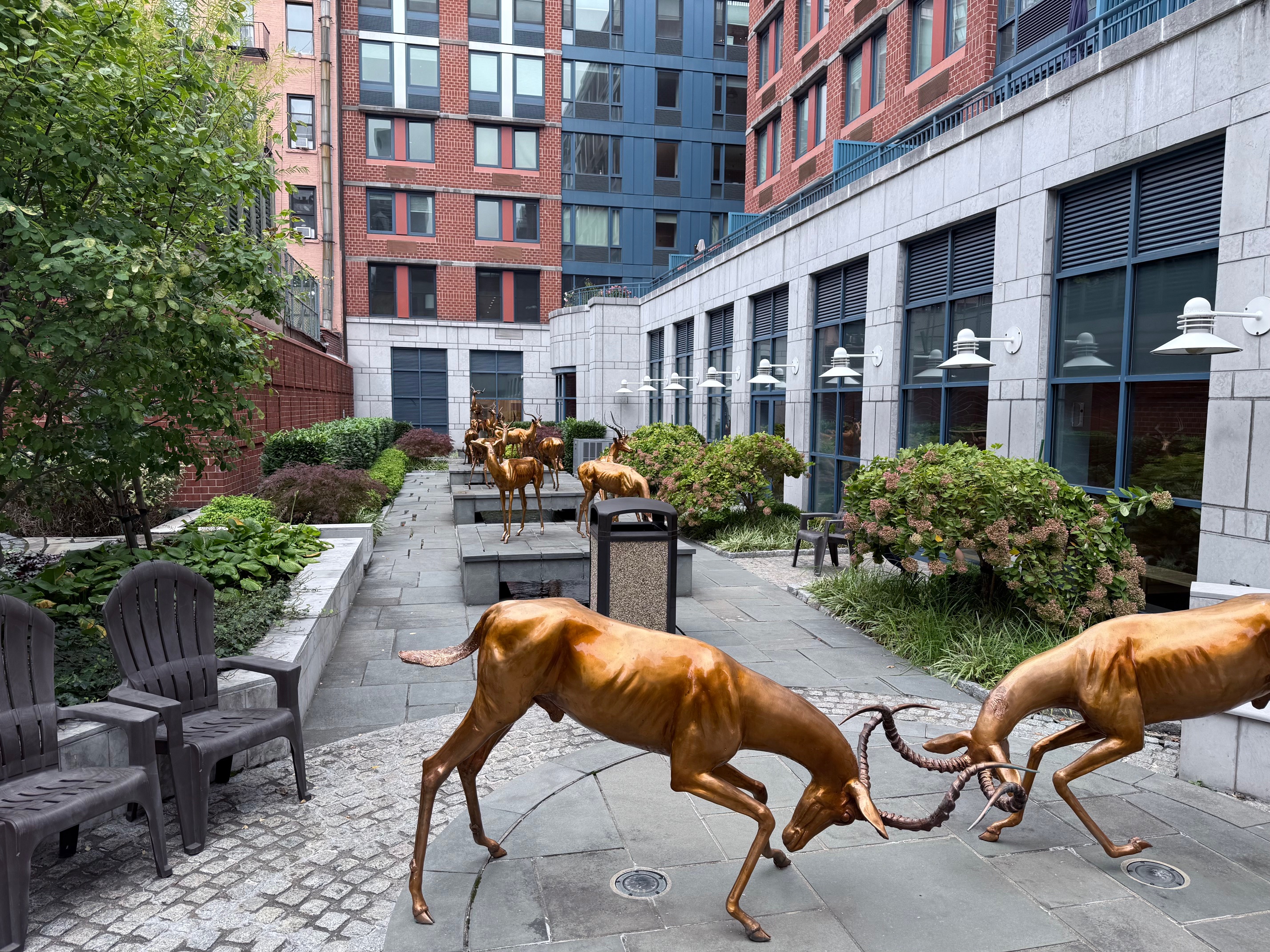 404 East 76th Street, Unit 4M Manhattan, NY 10021 - Photo 10 of 13 a view of a swimming pool and chairs in back yard of the building