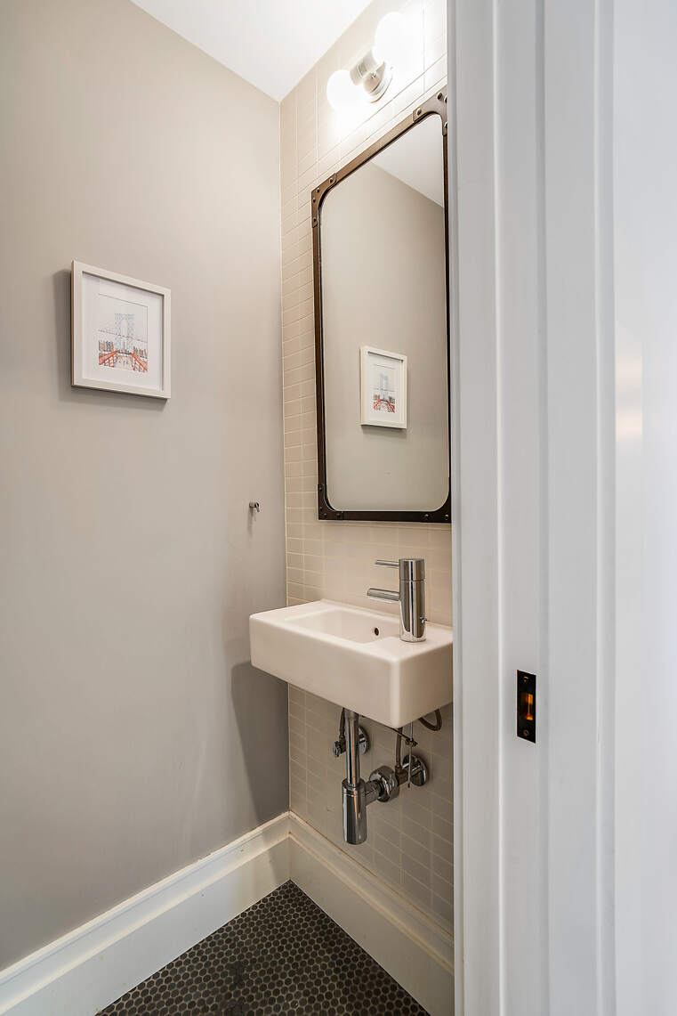 60 Pineapple Street, Unit 7I Brooklyn, NY 11201 - Photo 11 of 14 a bathroom with a sink and a mirror
