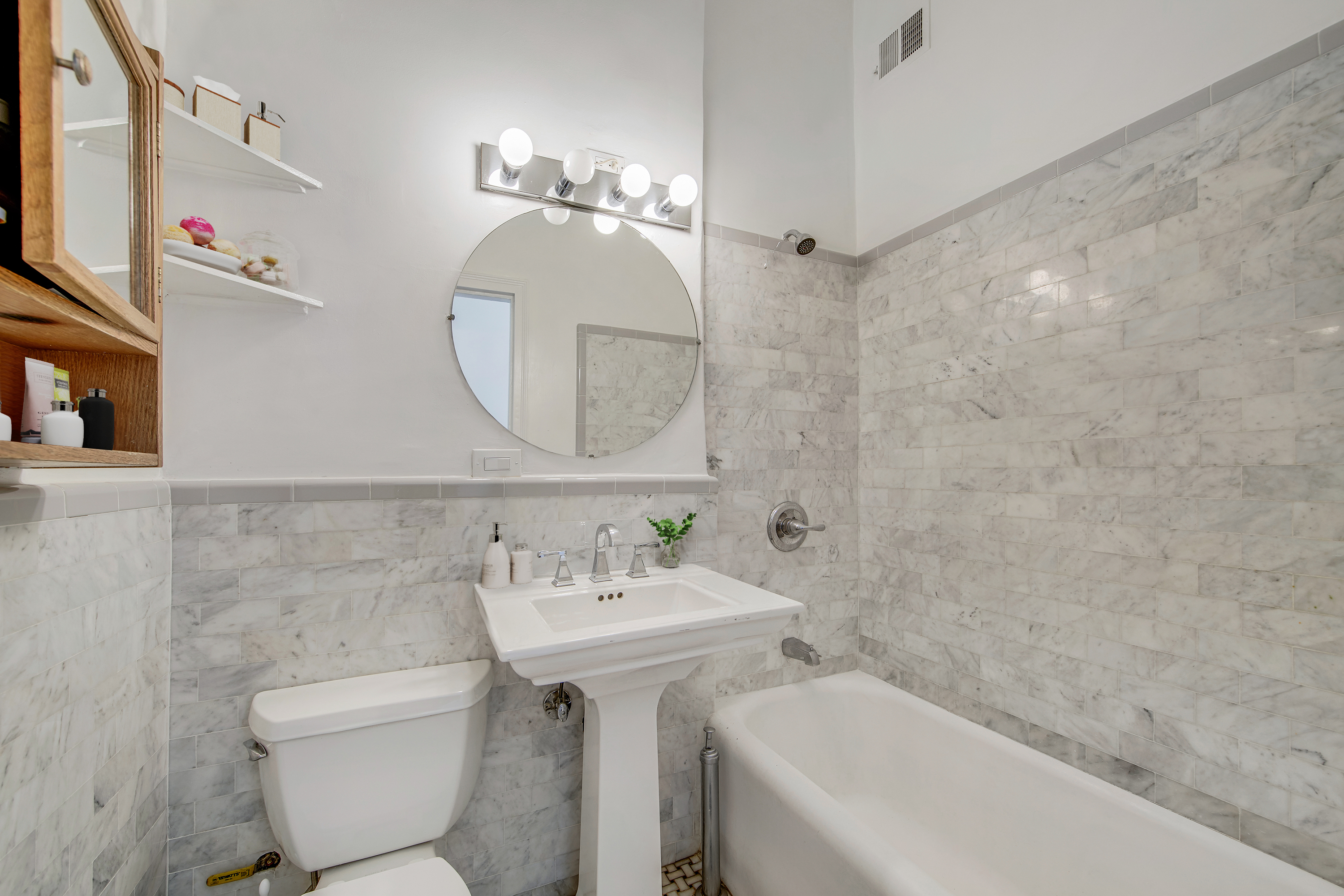 1 Sheridan Square, Unit 4E Manhattan, NY 10014 - Photo 5 of 10 a bathroom with a sink toilet and a mirror