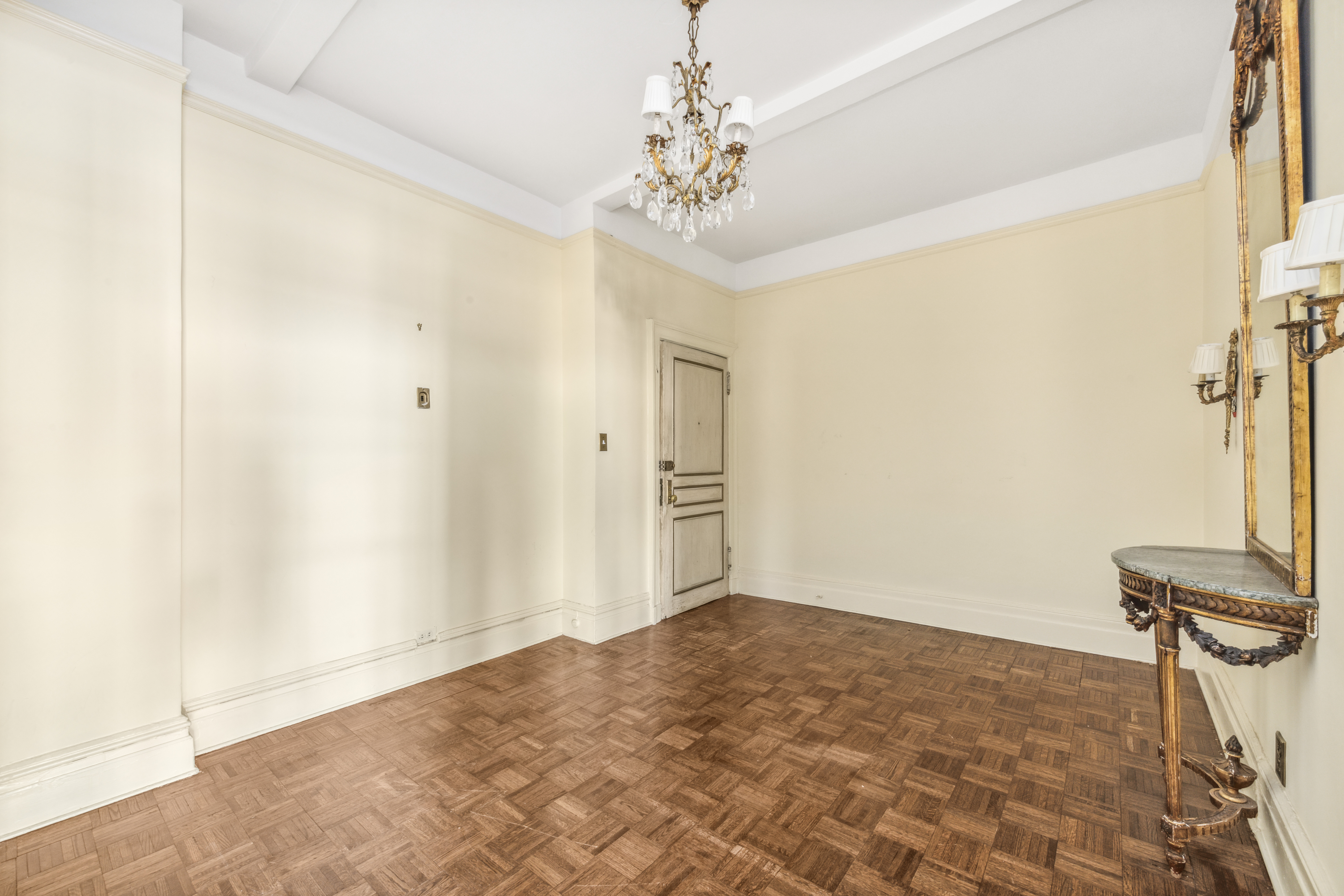 130 East 67th Street, Unit 9C Manhattan, NY 10065 - Photo 12 of 20 a view of a hallway with a chandelier