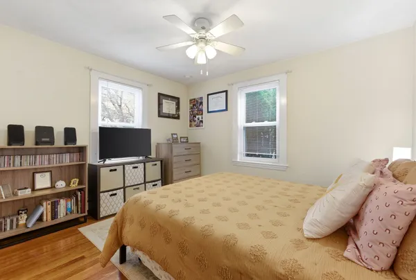 a bedroom with a bed and a large window