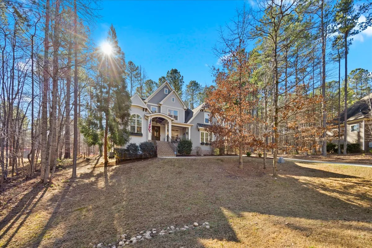 a view of a house with a yard and garage