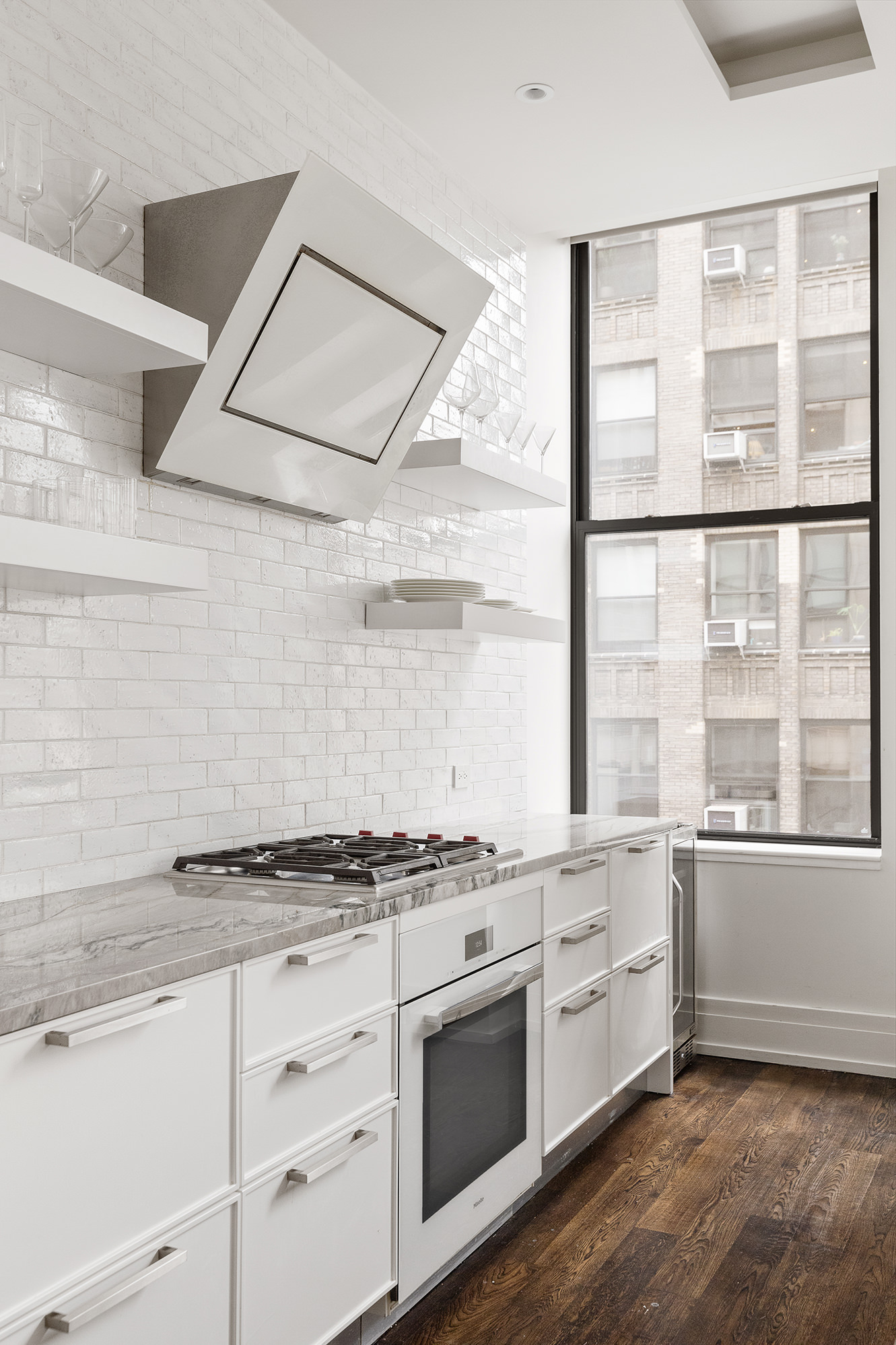 260 Park Avenue South, Unit 6B Manhattan, NY 10010 - Photo 5 of 13 a kitchen with stainless steel appliances granite countertop a stove and a white cabinets