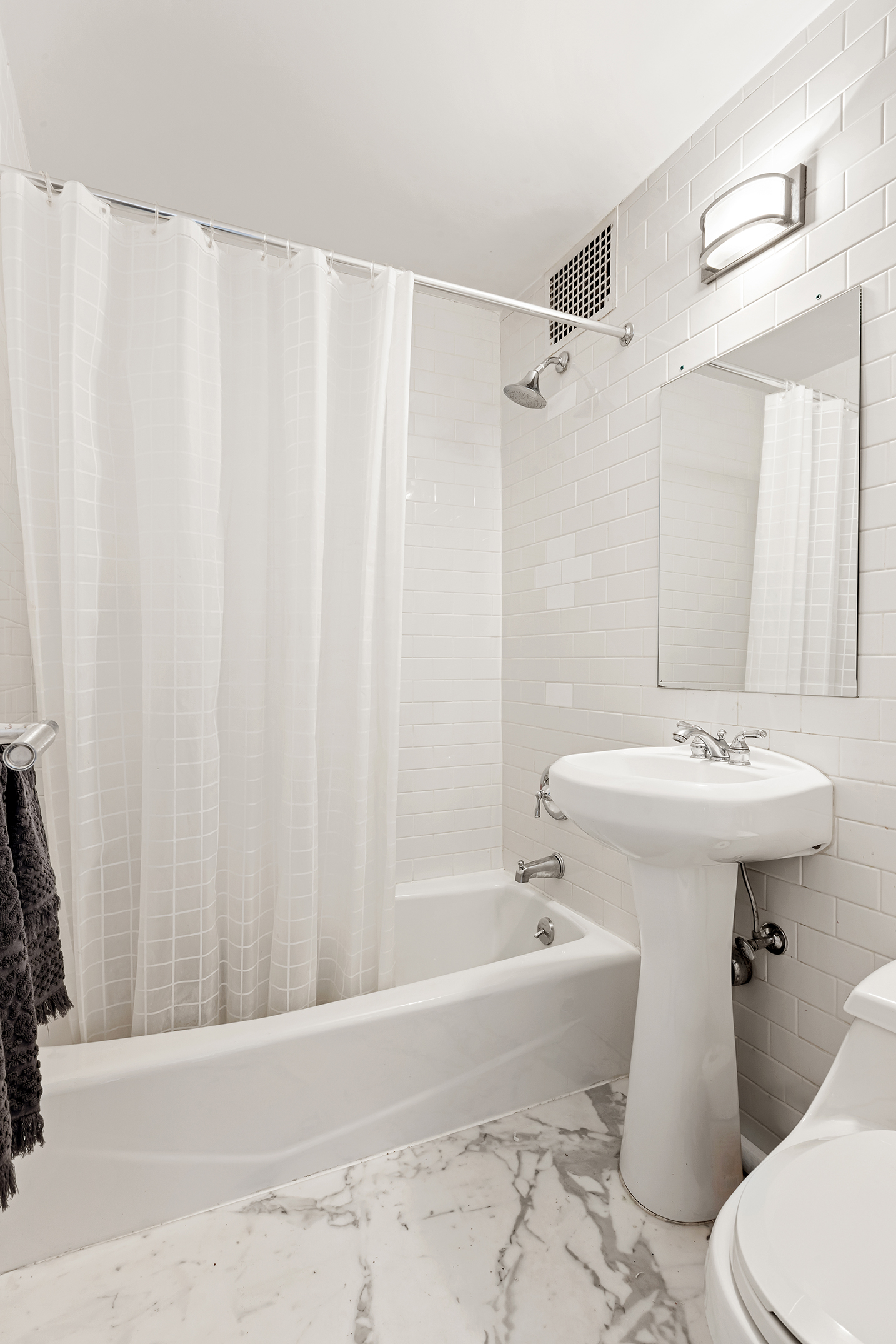 159 East 63rd Street, Unit 2/3 Manhattan, NY 10065 - Photo 11 of 13 a bathroom with a sink toilet and shower