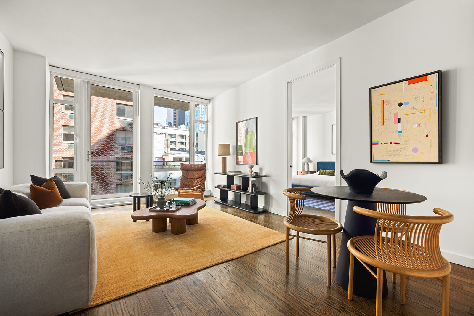 133 West 22nd Street, Unit 8G Manhattan, NY 10011 - Photo 2 of 16 a living room with furniture and floor to ceiling windows