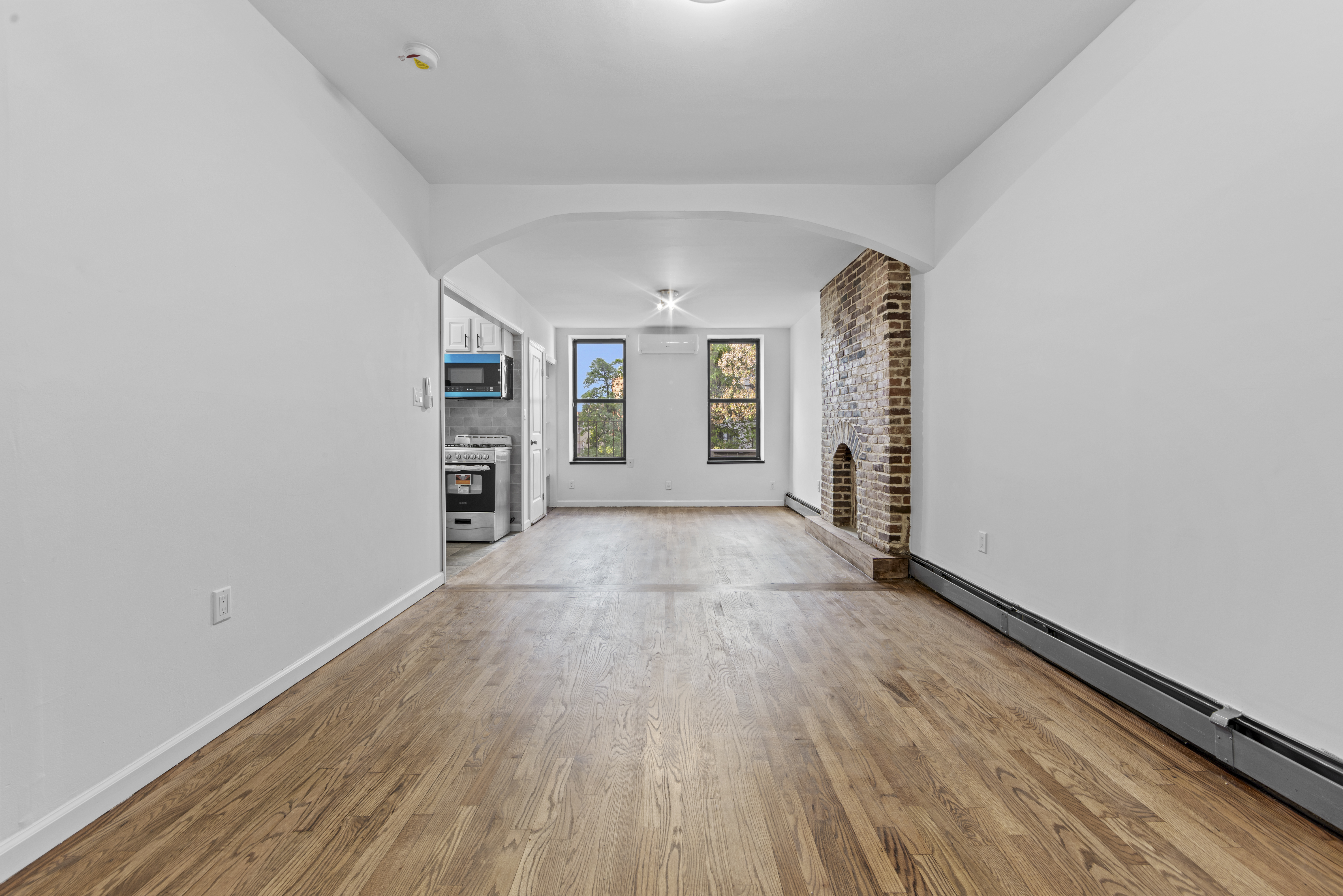 1061 Fulton Street, Unit 3 Brooklyn, NY 11238 - Photo 1 of 14 wooden floor in an empty room with a window