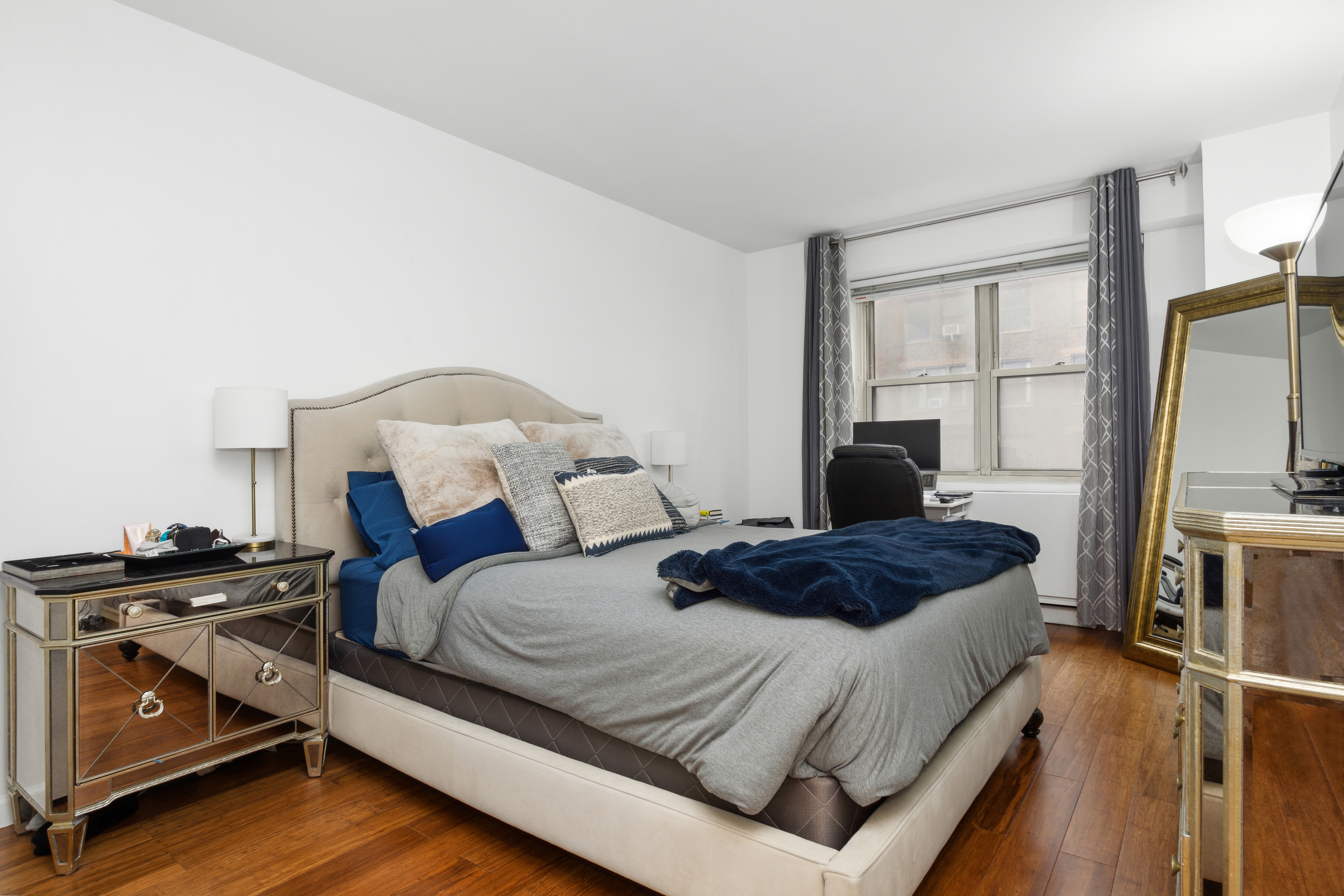 400 East 54th Street, Unit 7D Manhattan, NY 10022 - Photo 3 of 6 a bedroom with a bed and a flat screen tv