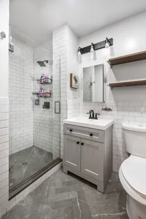 a bathroom with a sink toilet and shower