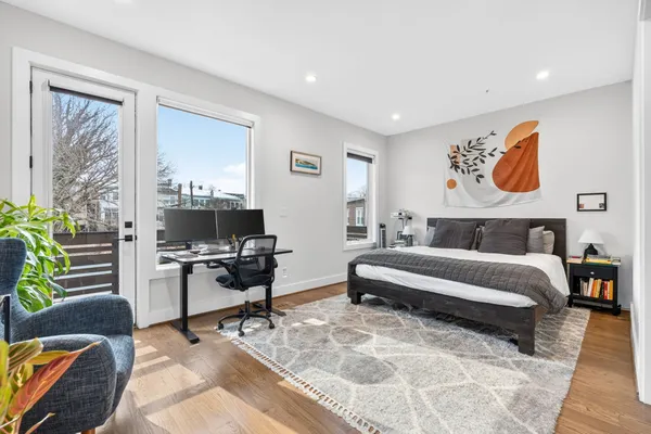 a bedroom with a bed and glass walk in closet