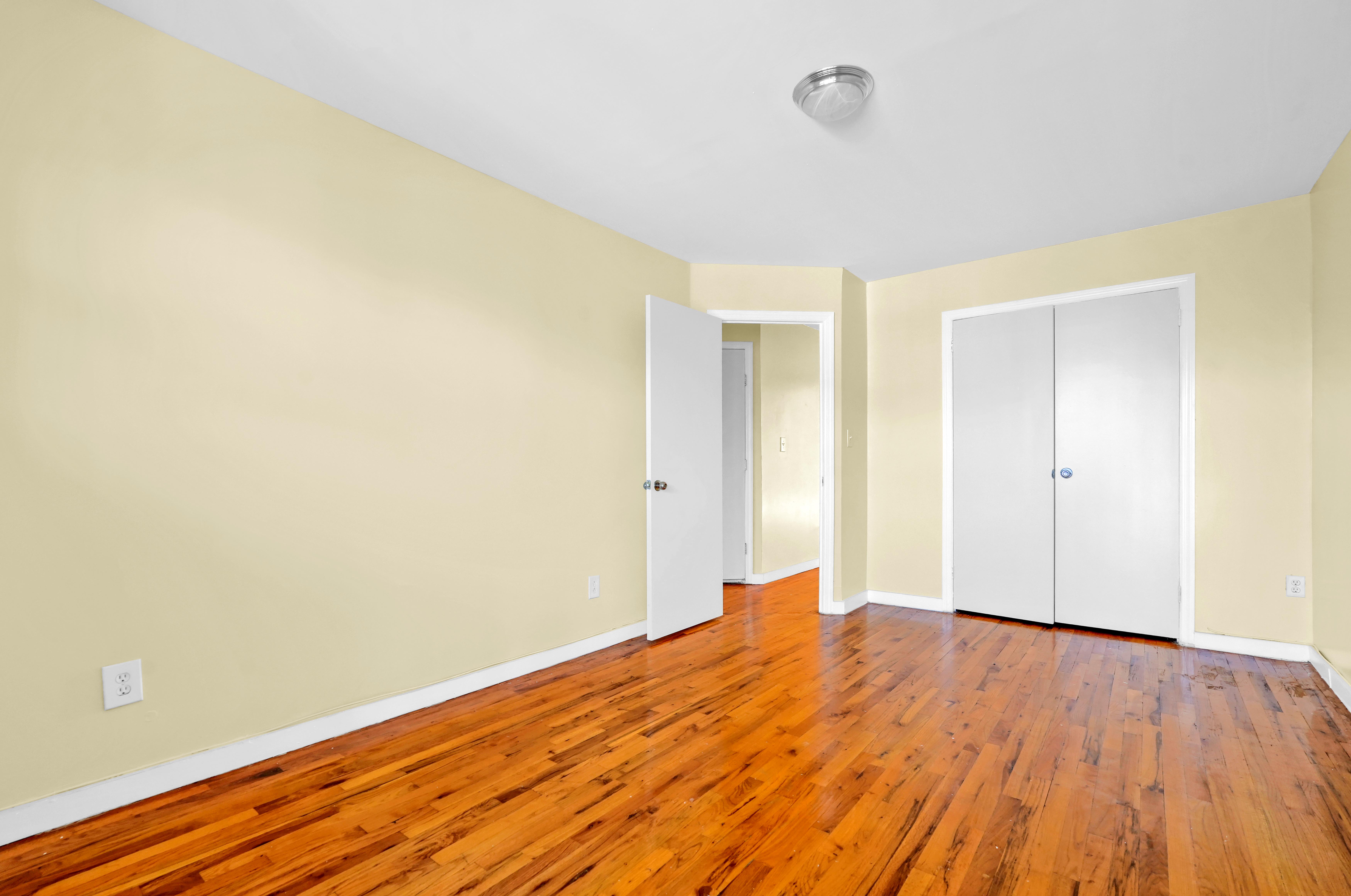 659 Jerome Street Brooklyn, NY 11207 - Photo 20 of 39 a view of empty room with wooden floor and fan