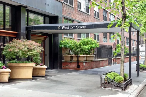 a front view of a building with potted plants
