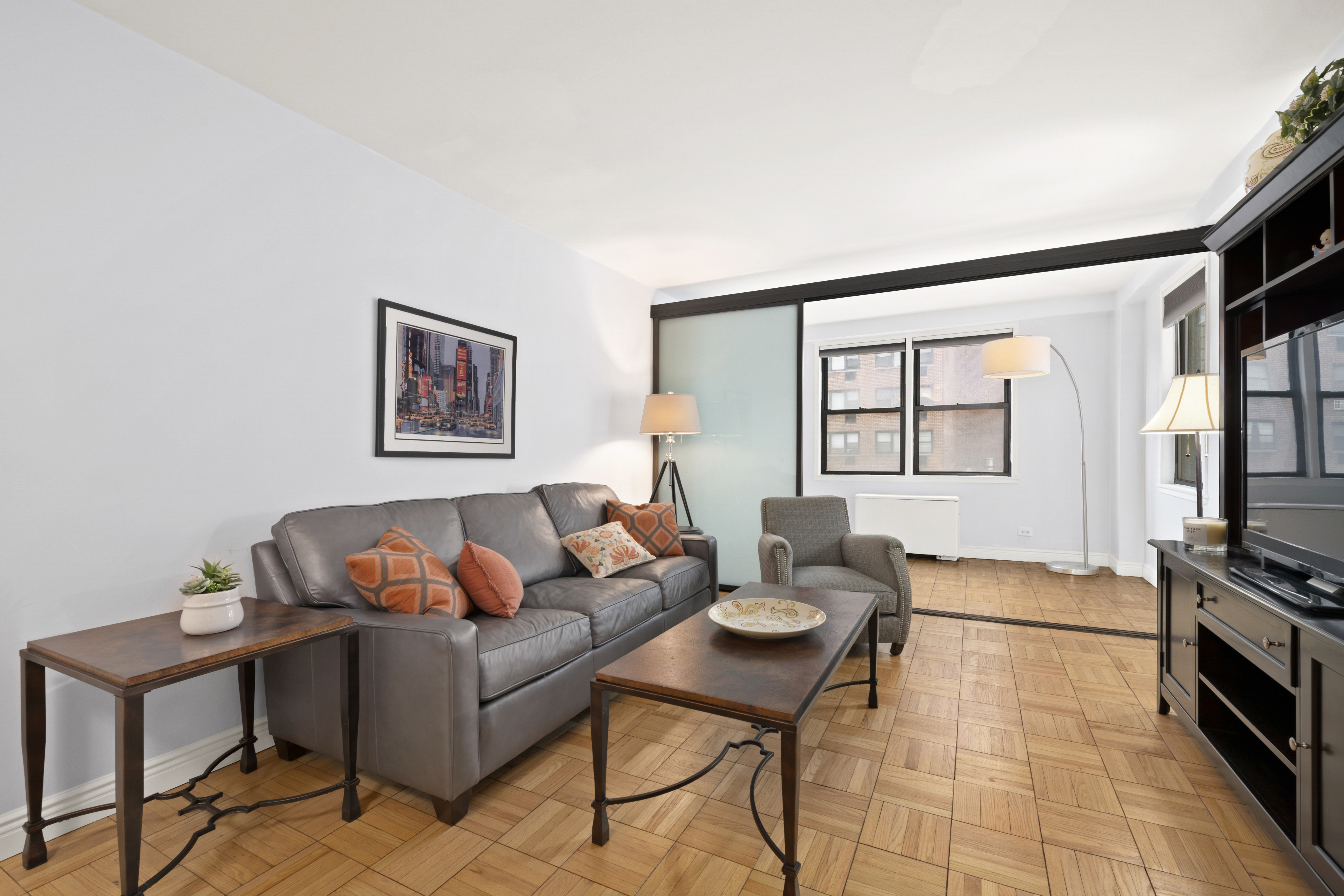 201 East 21st Street, Unit 7A Manhattan, NY 10010 - Photo 1 of 7 a living room with furniture and a window