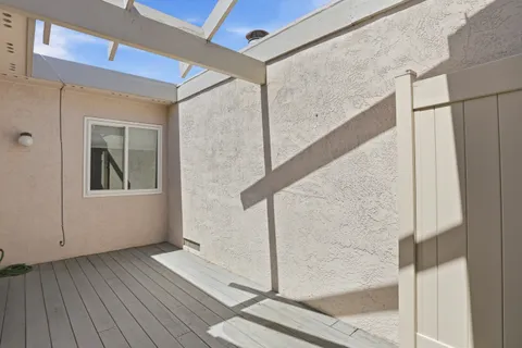 a view of balcony with wooden floor
