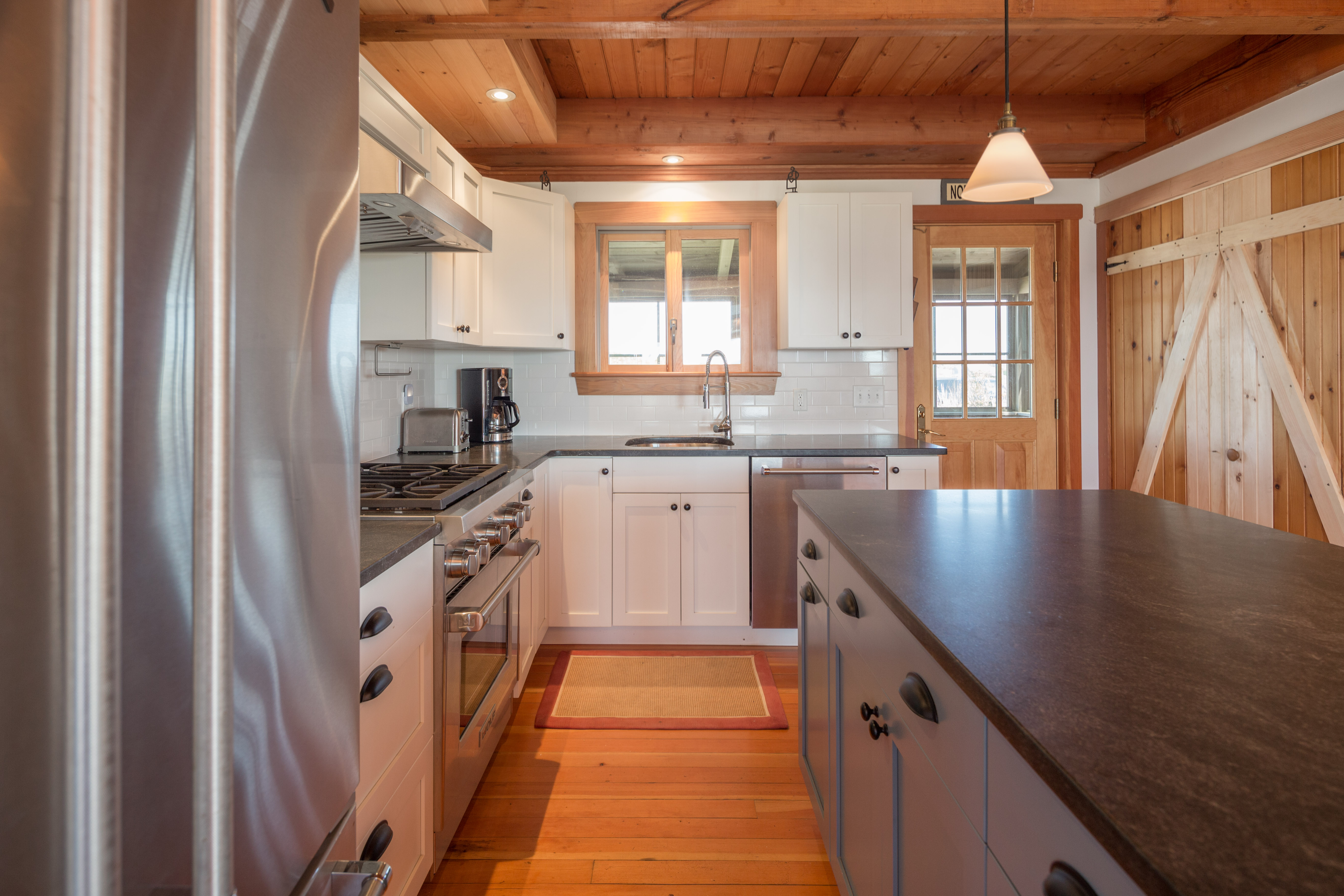 65 Nobadeer Avenue Nantucket, MA 02554 - Photo 4 of 20 a kitchen with stainless steel appliances granite countertop a sink a stove and a refrigerator