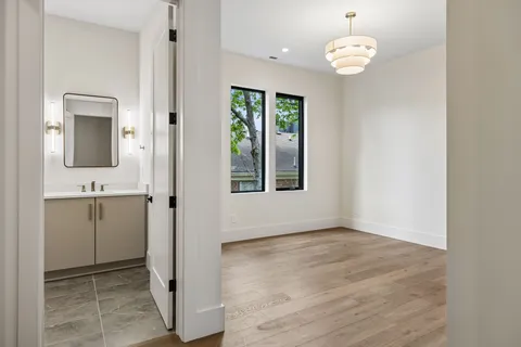 a bathroom with a granite countertop toilet and a sink