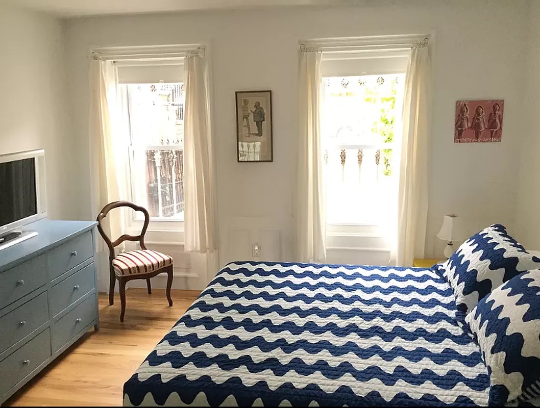 1370 Pacific Street, Unit 1 Brooklyn, NY 11216 - Photo 3 of 9 a bedroom with a bed and a chair