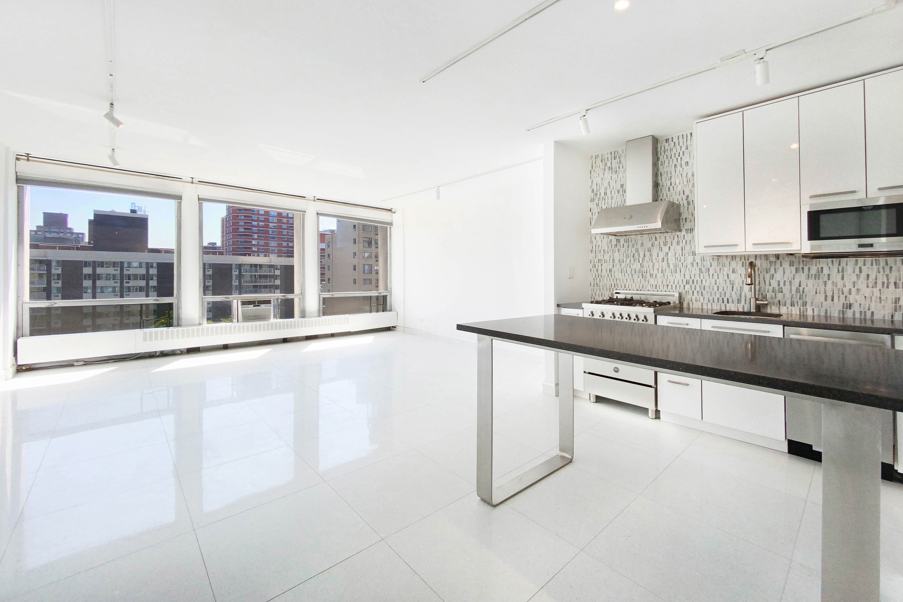 a kitchen with stainless steel appliances granite countertop a sink and cabinets