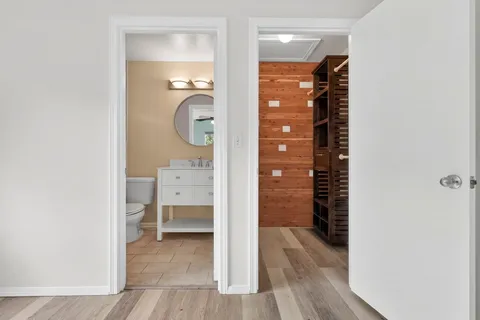 a bathroom with a walk in closet and a window