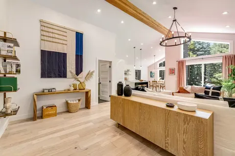 a large kitchen with kitchen island a large counter space a sink appliances and cabinets