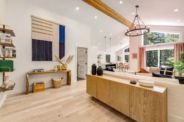 a large kitchen with kitchen island a large counter space a sink appliances and cabinets