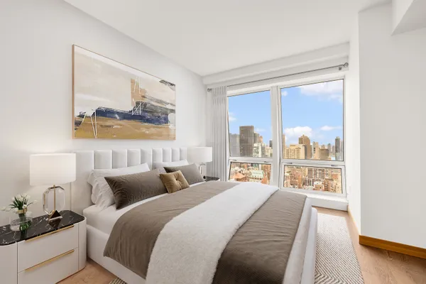 a bedroom with a large bed and a window