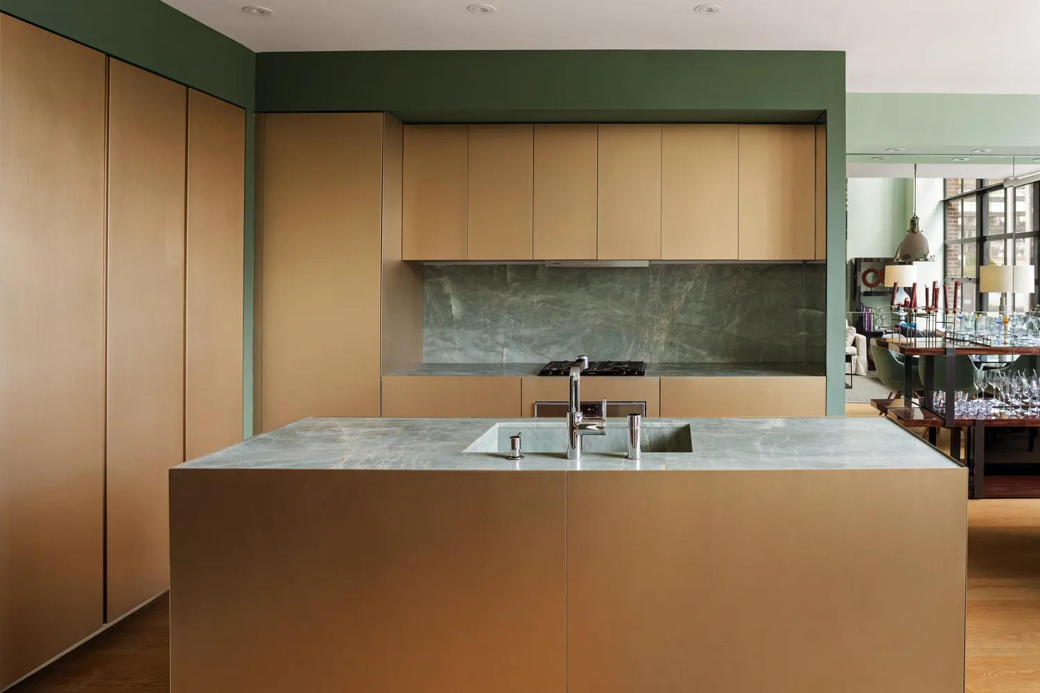 a kitchen with kitchen island a sink a stove and a microwave oven