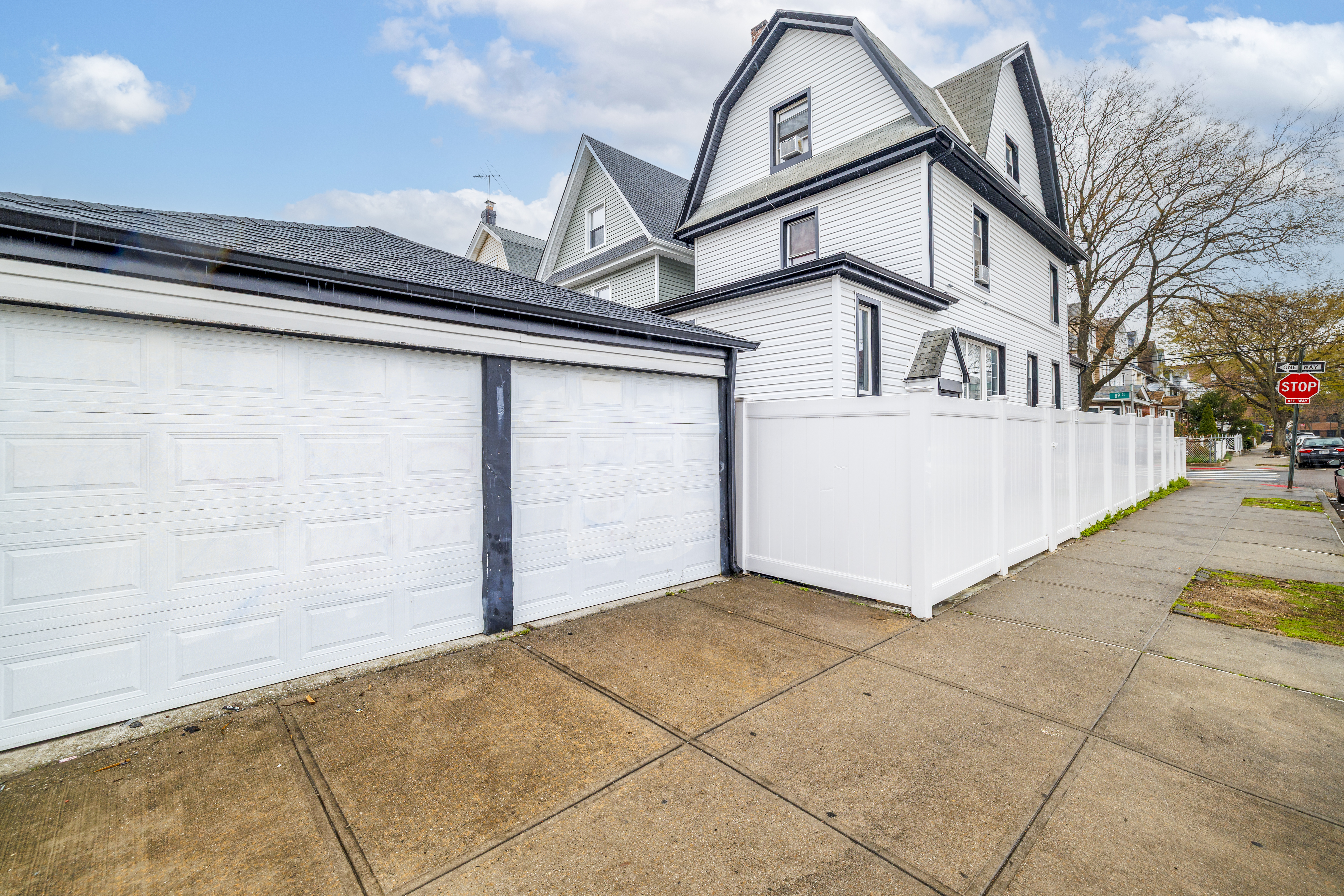 87-46 89th Street Queens, NY 11421 - Photo 17 of 25 a view of a white house with a outdoor space