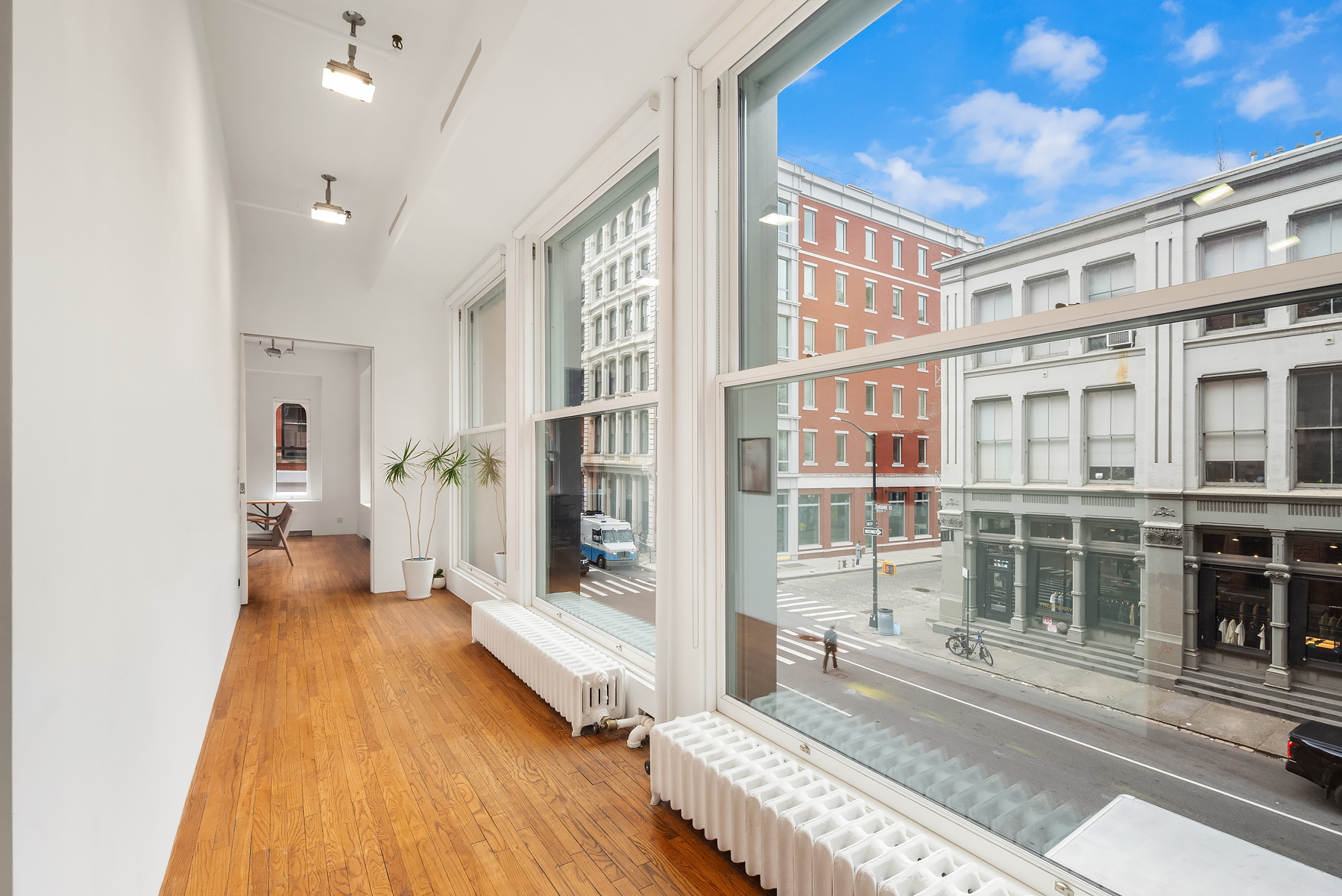 59 Wooster Street Manhattan, NY 10012 - Photo 2 of 10 a spacious bedroom with a bed and a large window