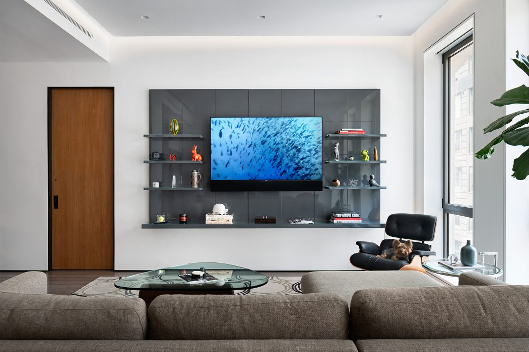 40 West 17th Street, Unit 9A Manhattan, NY 10011 - Photo 2 of 12 a living room with furniture a couch and a flat screen tv