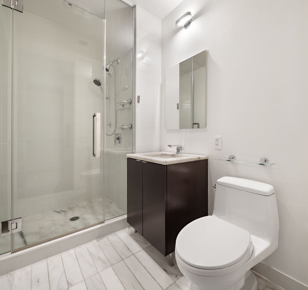 101 Warren Street, Unit 11L Manhattan, NY 10007 - Photo 16 of 26 a bathroom with a sink toilet and shower