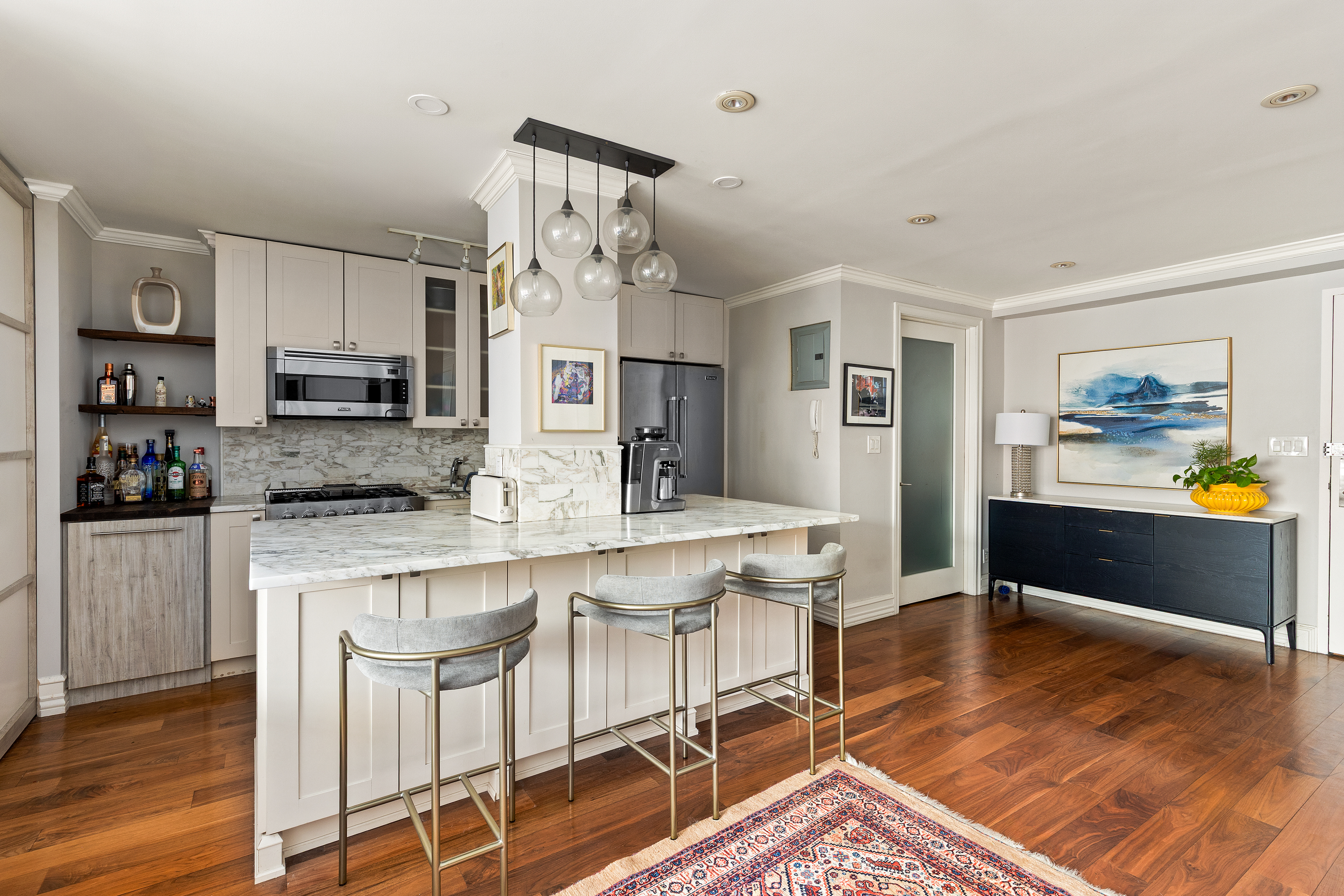 310 East 70th Street, Unit 6A Manhattan, NY 10021 - Photo 6 of 9 a kitchen with stainless steel appliances kitchen island granite countertop a refrigerator and microwave