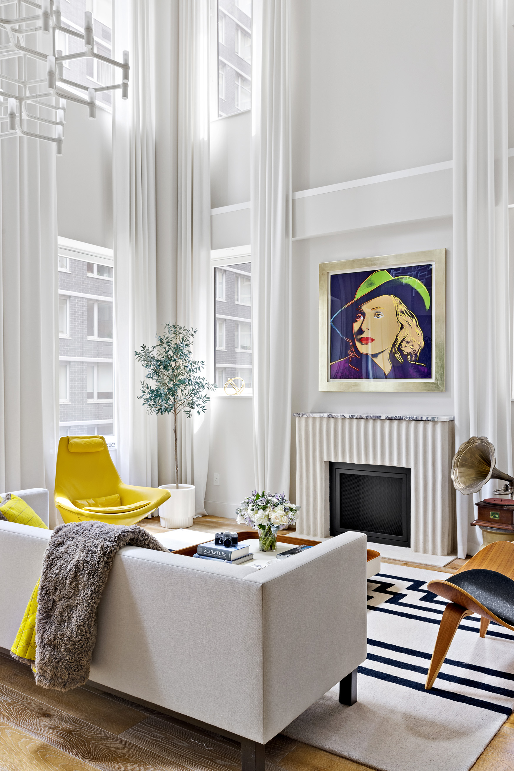 93 Worth Street, Unit 311 Manhattan, NY 10013 - Photo 8 of 17 a living room with a couch and a fireplace