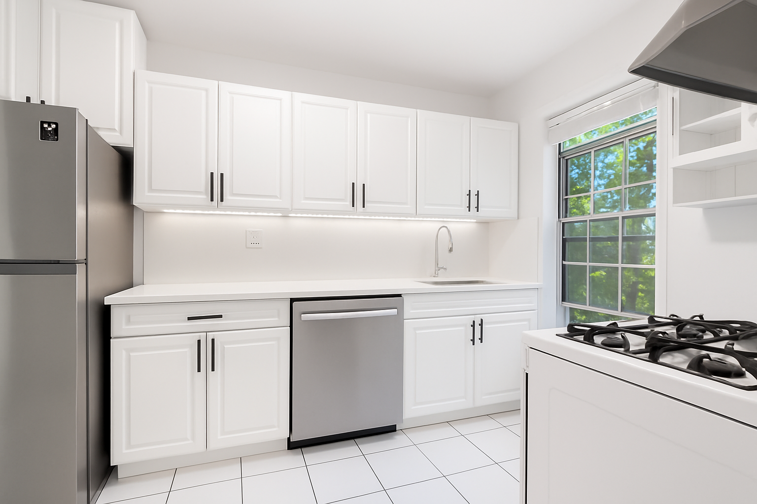 a kitchen with white cabinets and white appliances