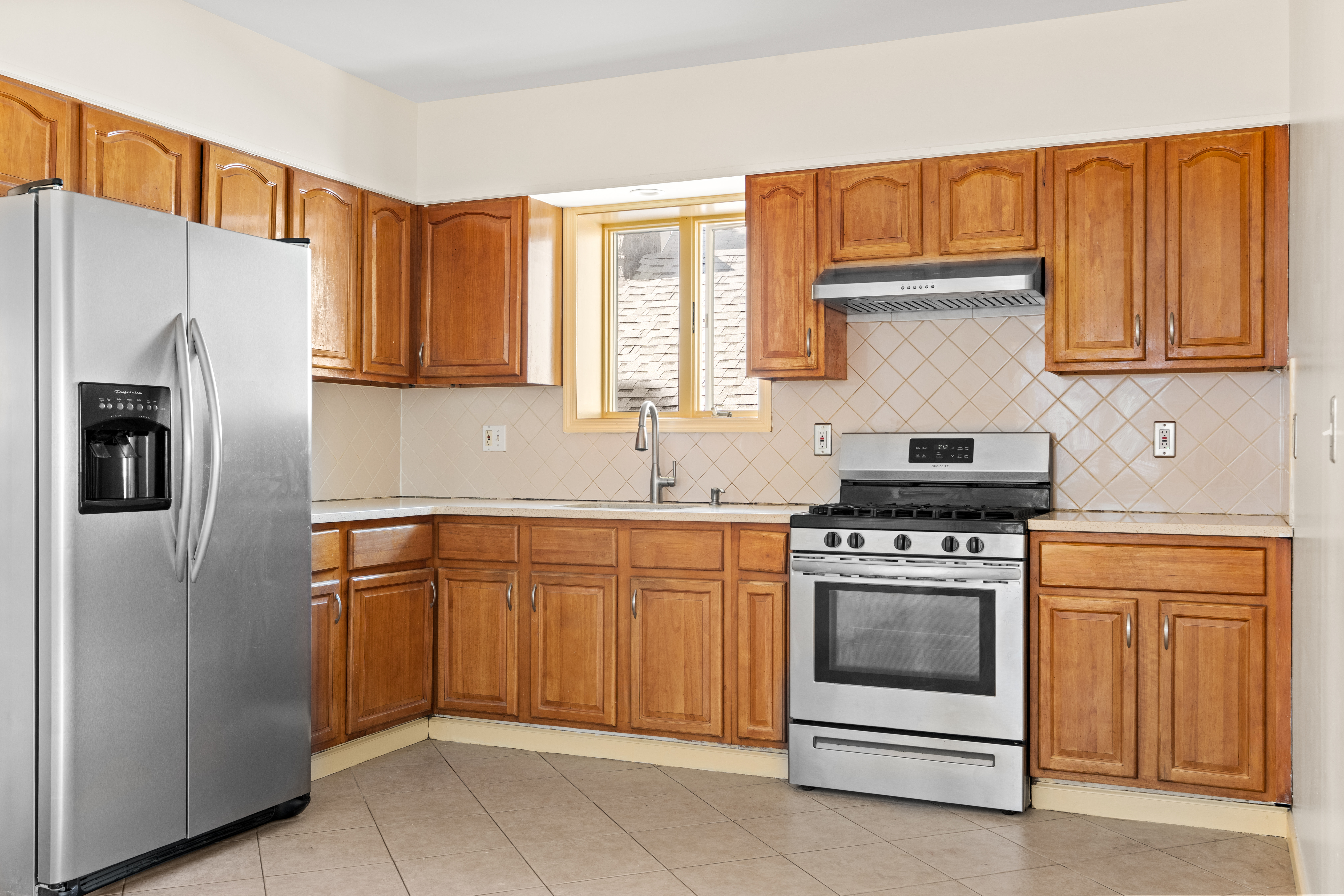 1920 83rd Street, Unit 3 Brooklyn, NY 11214 - Photo 3 of 9 a kitchen with stainless steel appliances granite countertop a refrigerator stove and sink