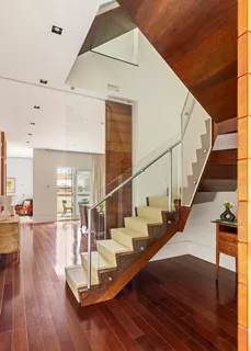 a view of entryway and hall with wooden floor