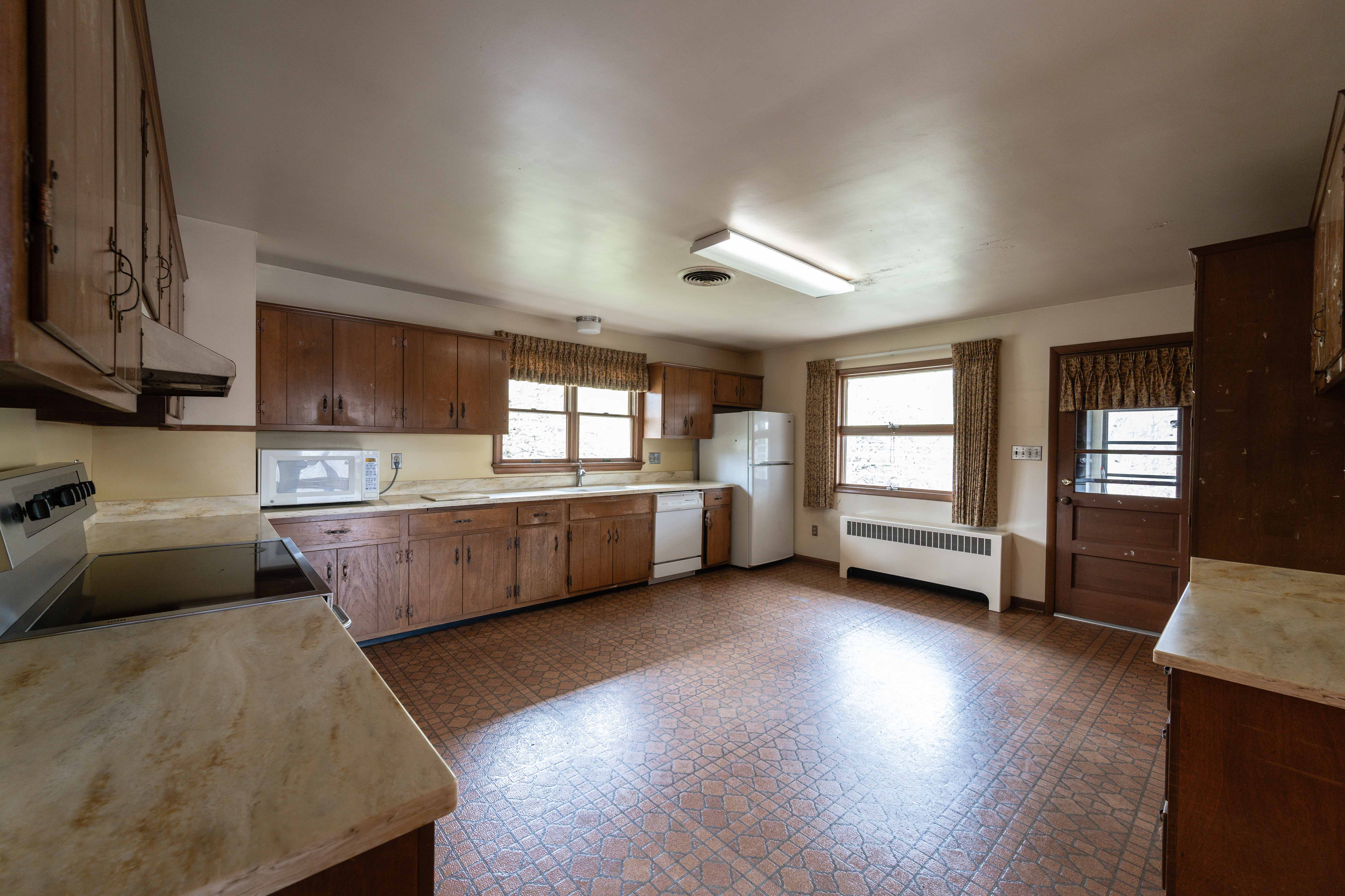 21730 Peach Tree Road Dickerson, MD 20842 - Photo 6 of 11 a kitchen with stainless steel appliances wooden floors and white cabinets