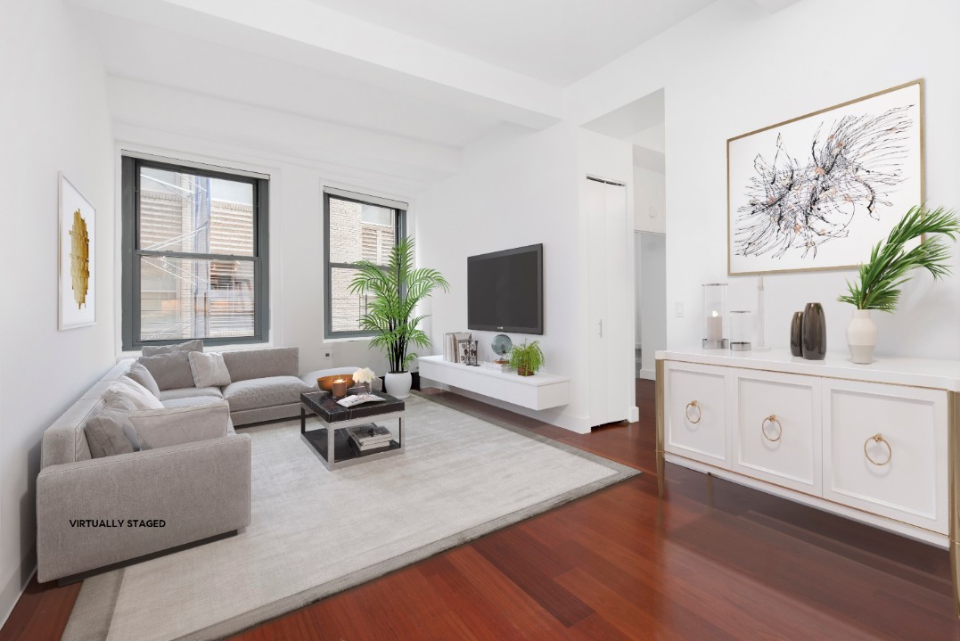 80 John Street, Unit 4C Manhattan, NY 10038 - Photo 1 of 11 a living room with furniture and a flat screen tv