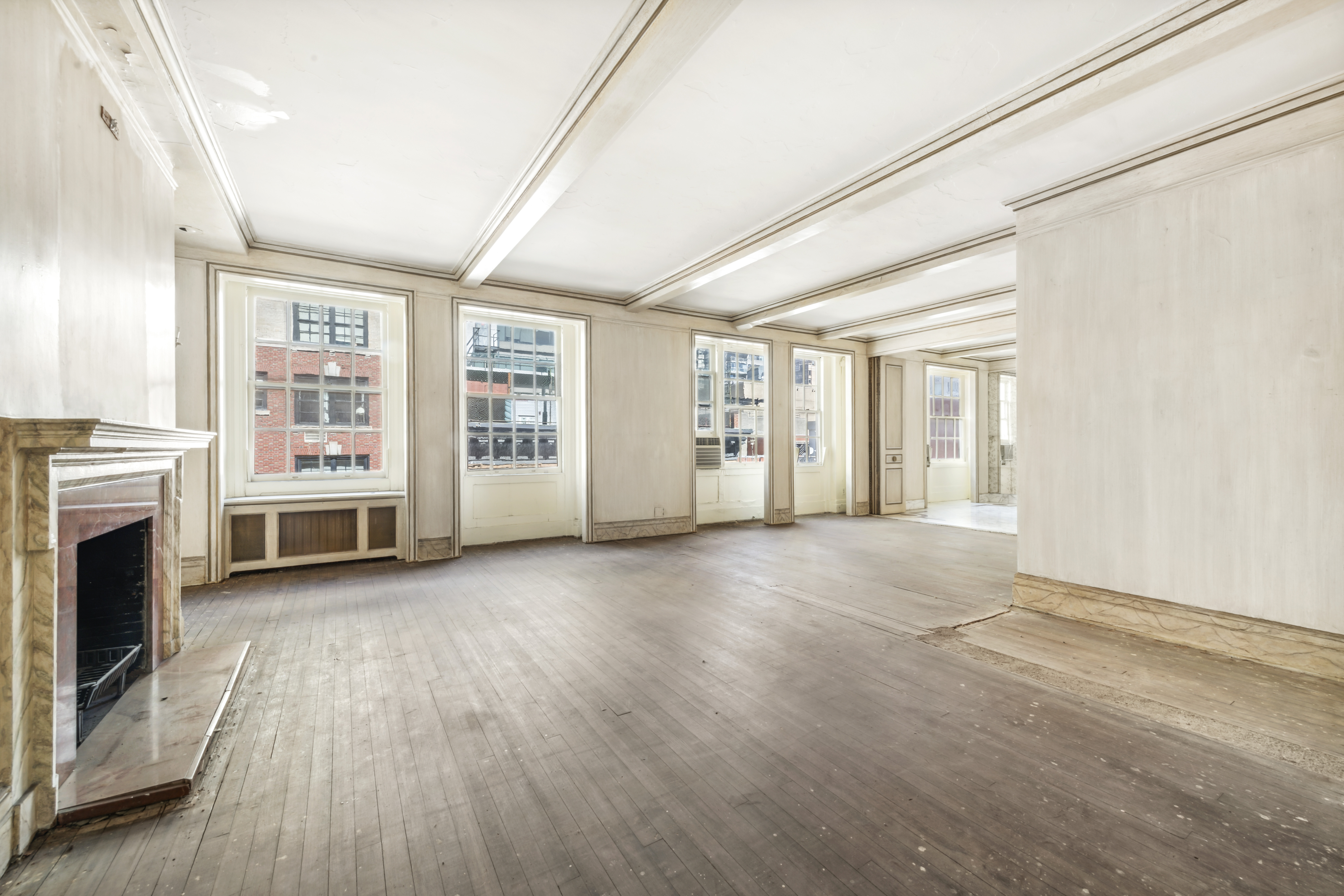 130 East 67th Street, Unit 9C Manhattan, NY 10065 - Photo 3 of 20 a view of a livingroom with an empty space and a fireplace