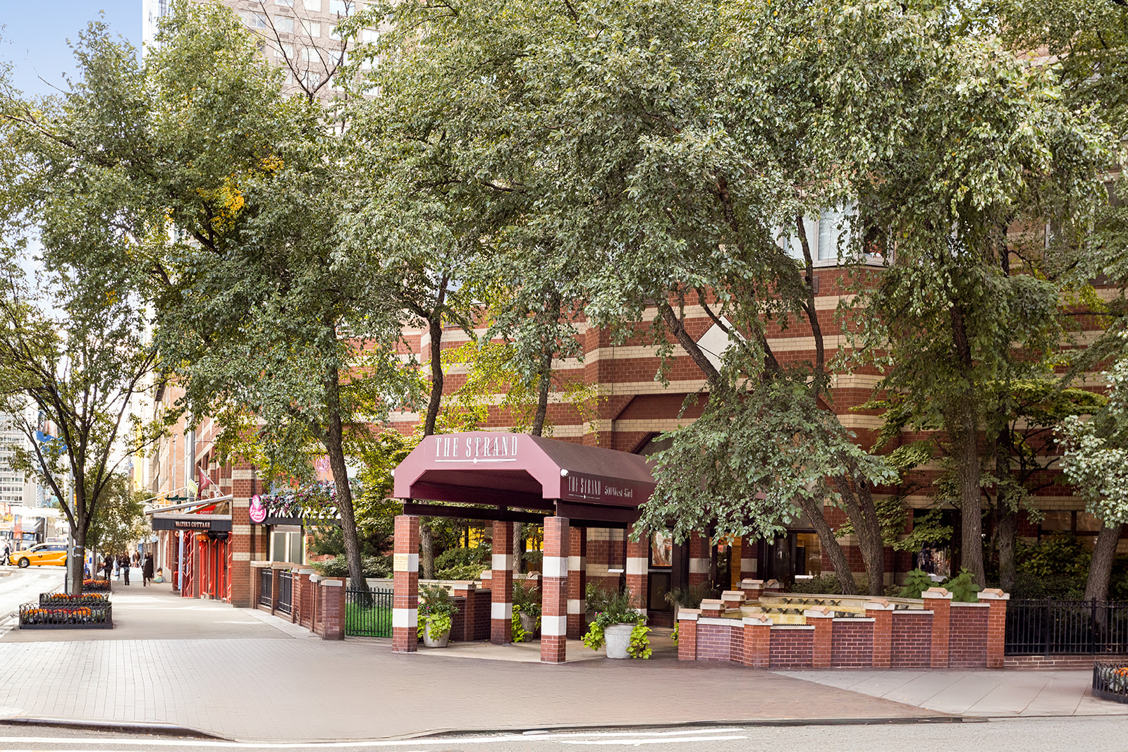 500 West 43rd Street, Unit 3B Manhattan, NY 10036 - Photo 18 of 19 a front view of a building with trees