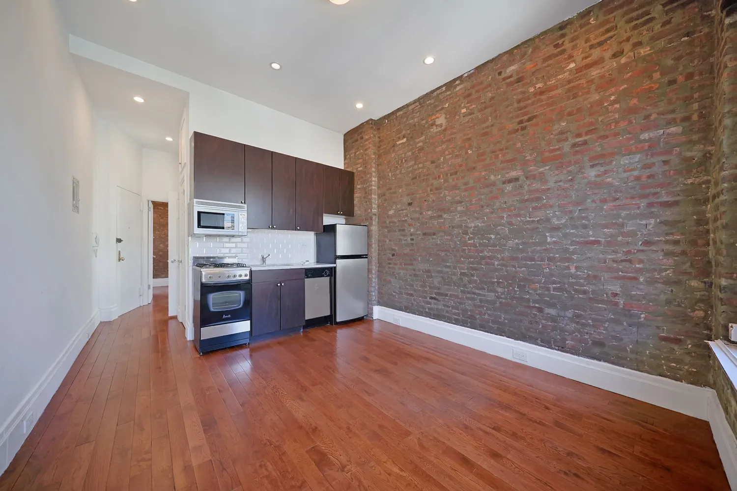 a kitchen with stainless steel appliances a refrigerator and a stove top oven