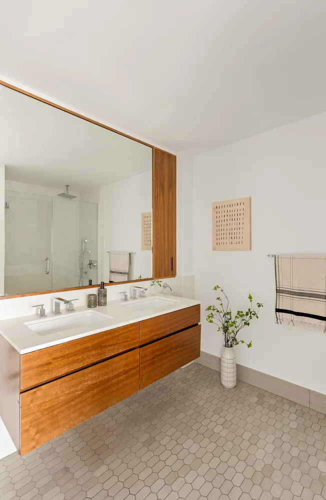a spacious bathroom with a tub sink and mirror