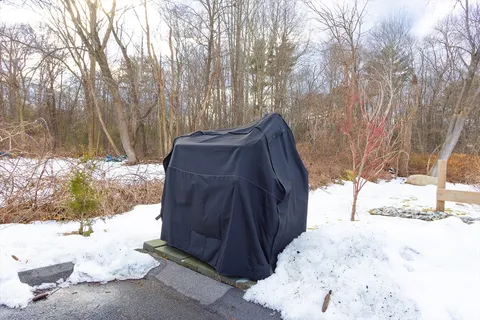 a view of backyard with table and chairs