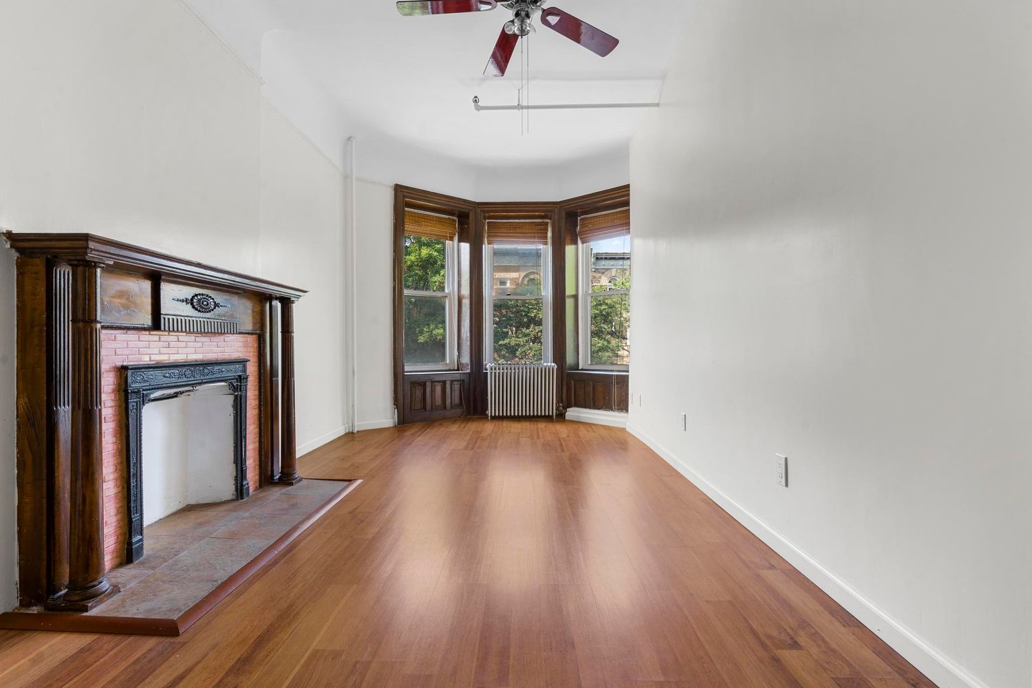 880 Park Place, Unit 2 Brooklyn, NY 11216 - Photo 4 of 12 a view of an empty room with a window and wooden floor