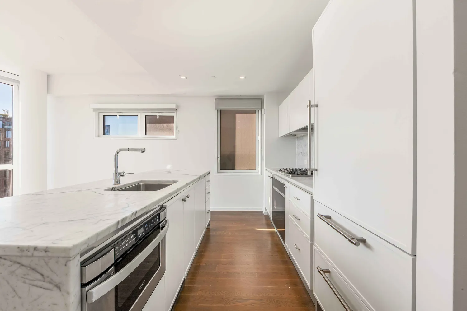 a kitchen with granite countertop a sink and stove top oven