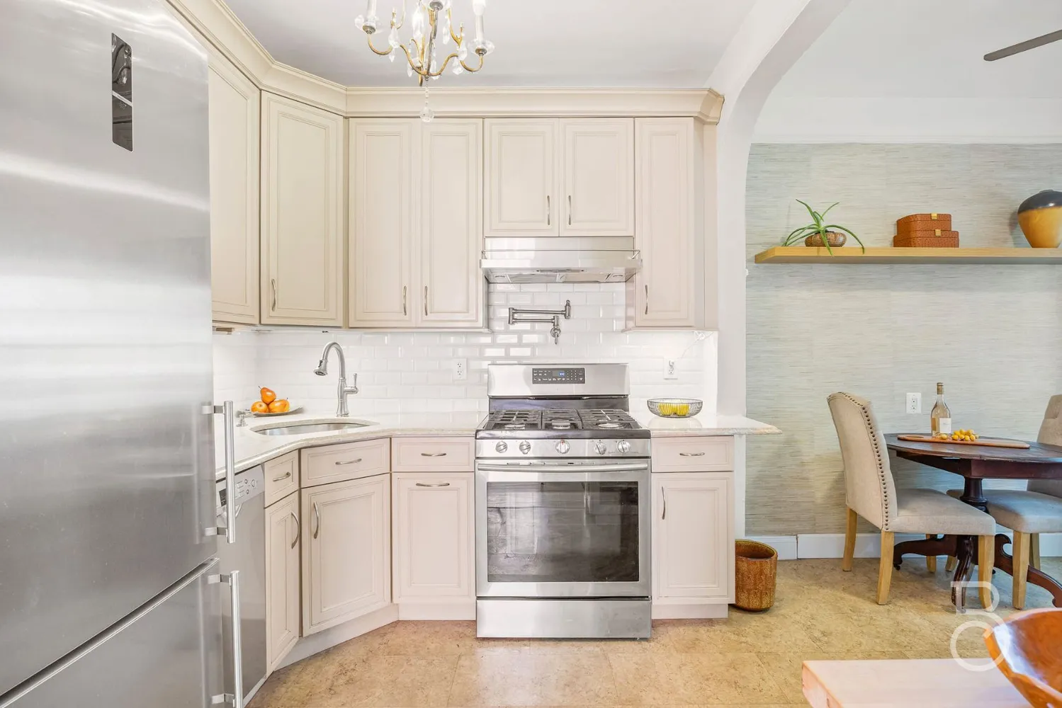 a kitchen with stainless steel appliances a stove a sink and cabinets